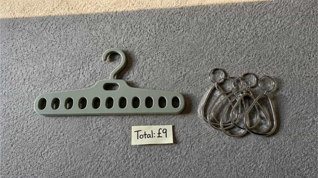 Budget-friendly wardrobe space hacks for a small rental bedroom using multi-hole hangers and shower rings